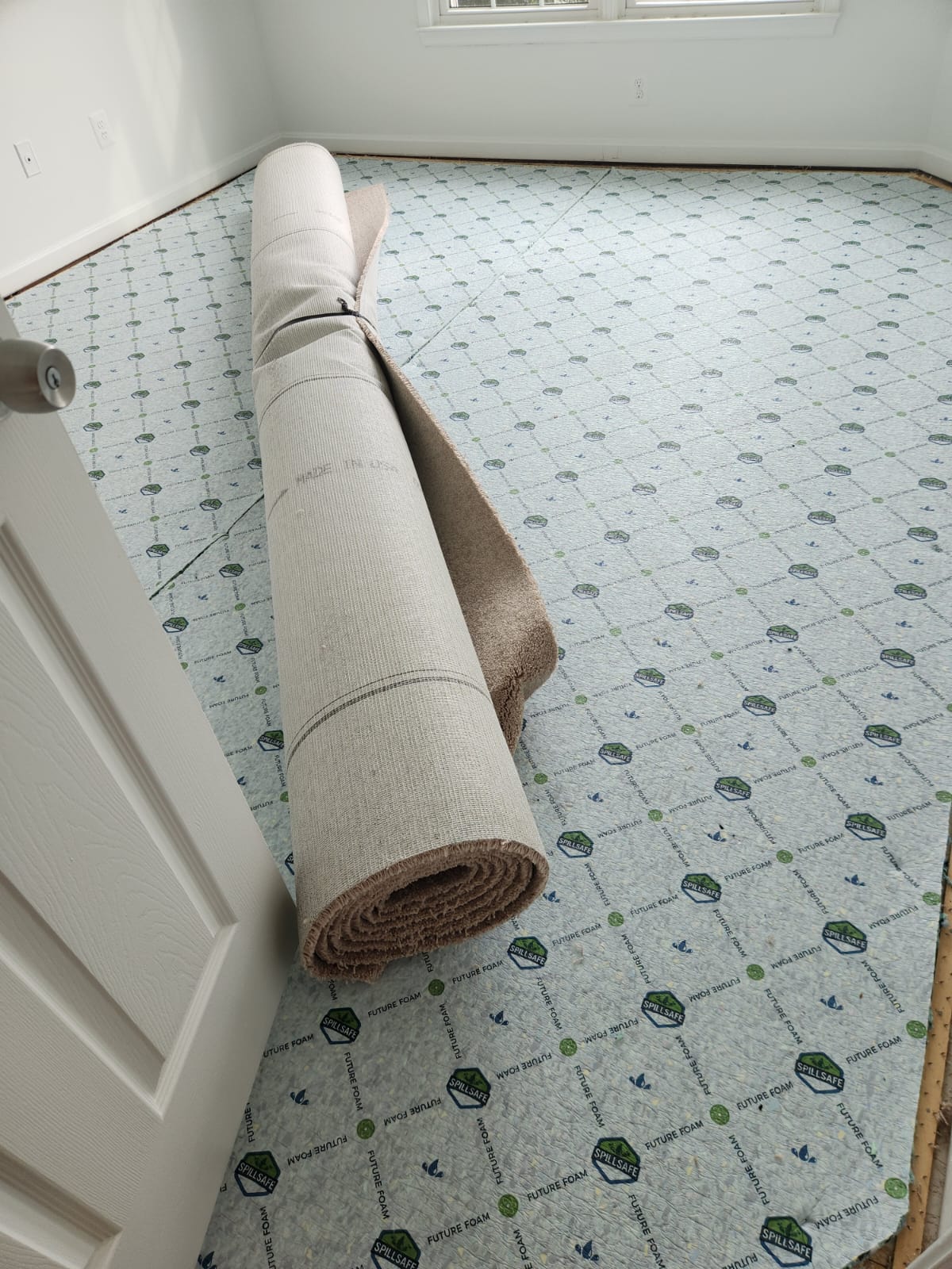 Carpet rolled up on new padding during replacement